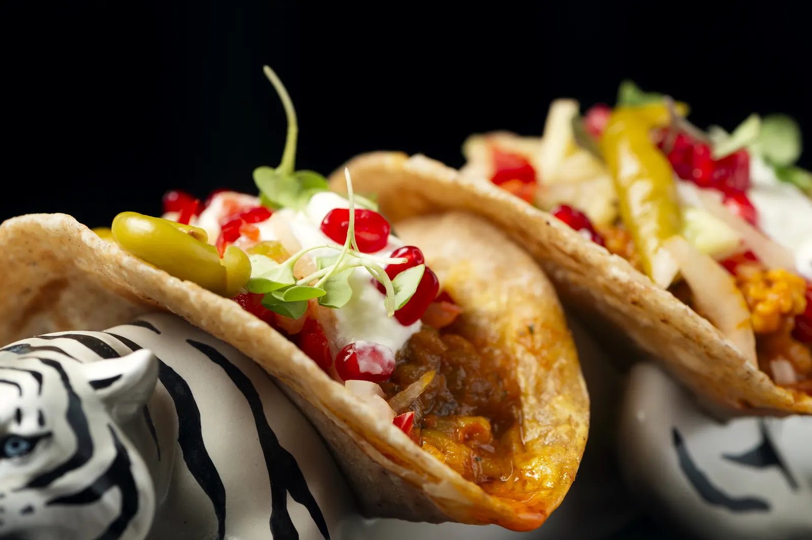 Tiger tacos up close: paratha bread with prawns, yoghurt and pomegranate, served on a tiger figure
