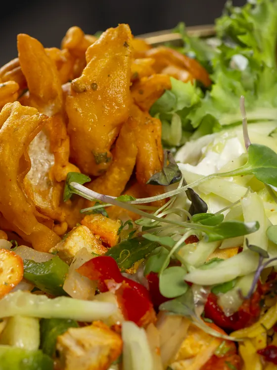 Buddha bowl up close: golden onion tempura, lettuce, cucumber, red pepper and sprouts