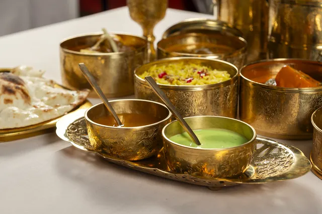 The two Lunch box sauces, one amber and one green, in brass bowls