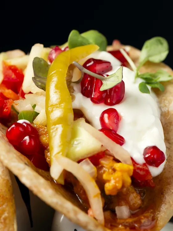 Tiger tacos up close: paratha bread with yoghurt, pomegranate, green chilli and sprouts